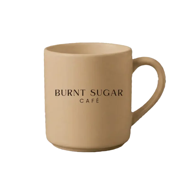 A caramel mug with Burnt Sugar's text logo.