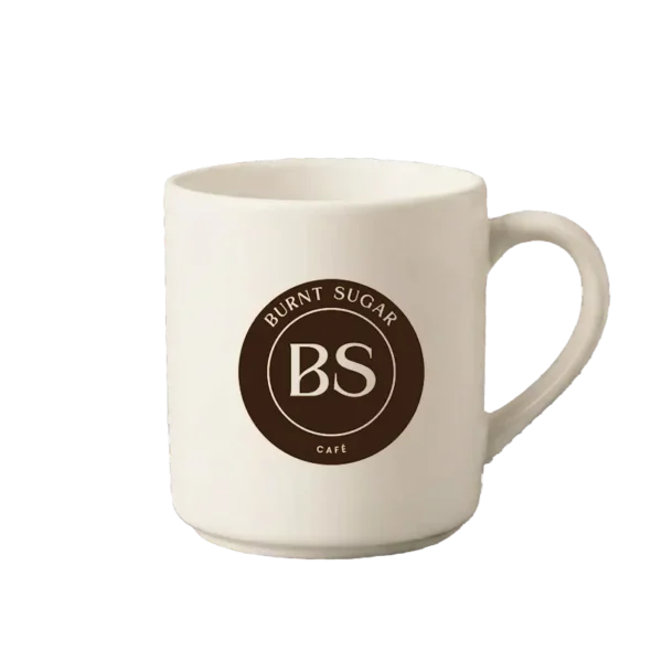 A cream mug with Burnt Sugar's round logo.
